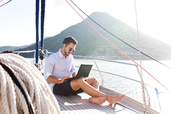 Thumb man on a boat with laptop