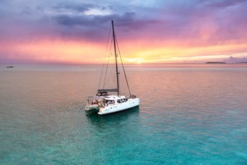 Thumb sailing catamaran anchored caribbean bahamas turquoise water sunset